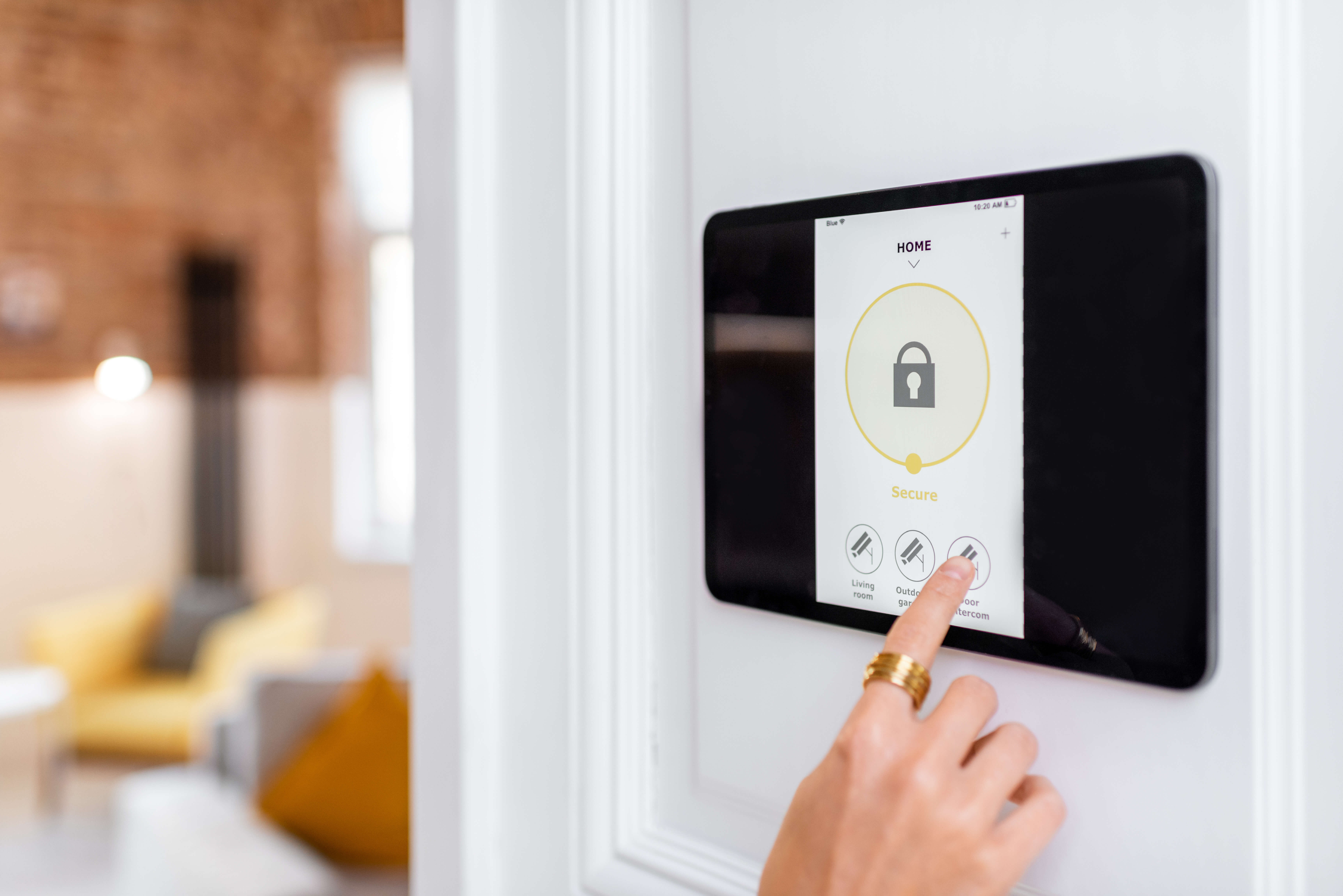 Hand selecting an option on a smart home system, representing insurance discounts available for features like wind mitigation, protective devices, and secured communities