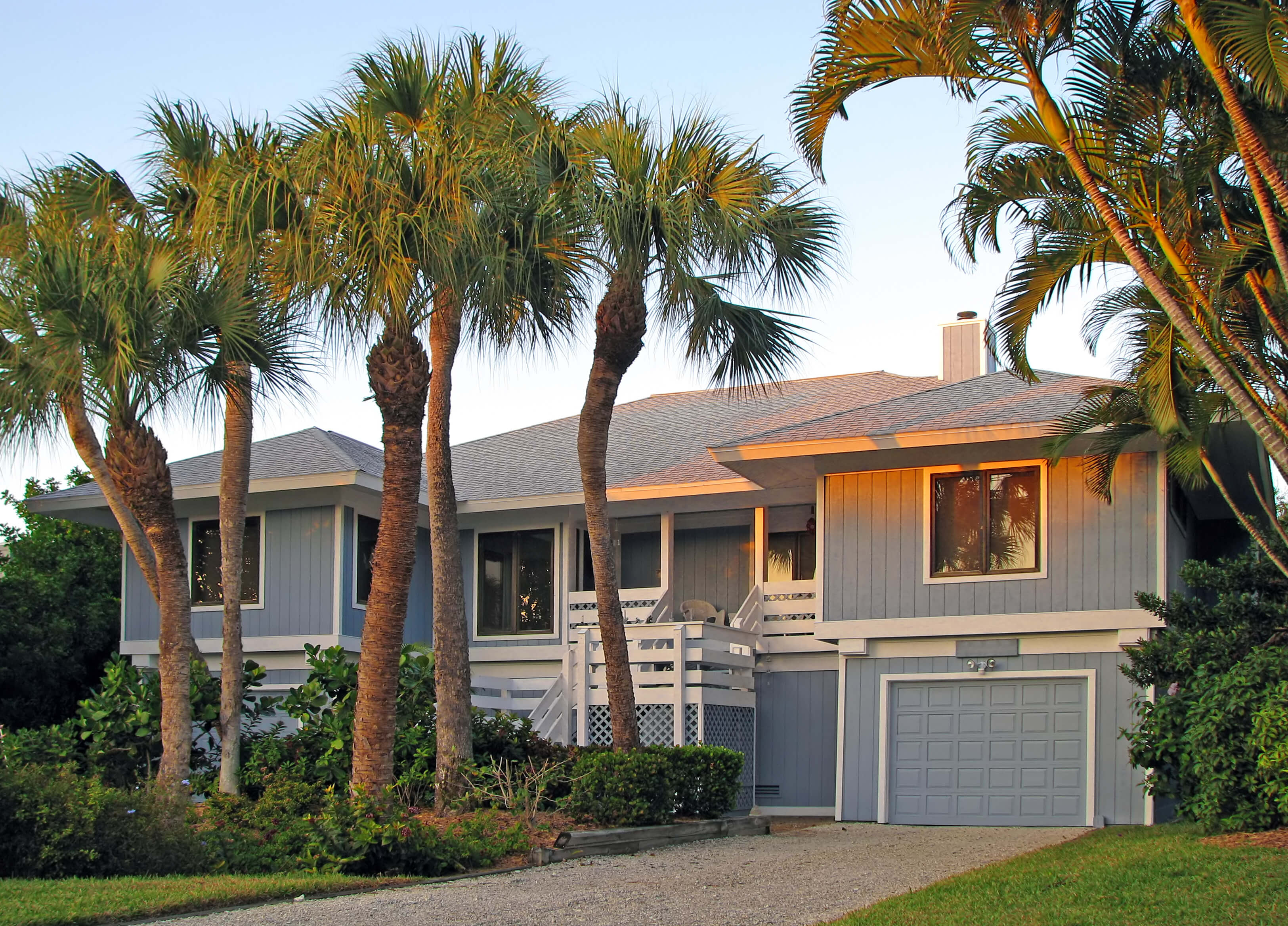 Elevated Florida home surrounded by palm trees, representing older properties that can be protected with American Integrity’s Integrity Select insurance product for reliable coverage