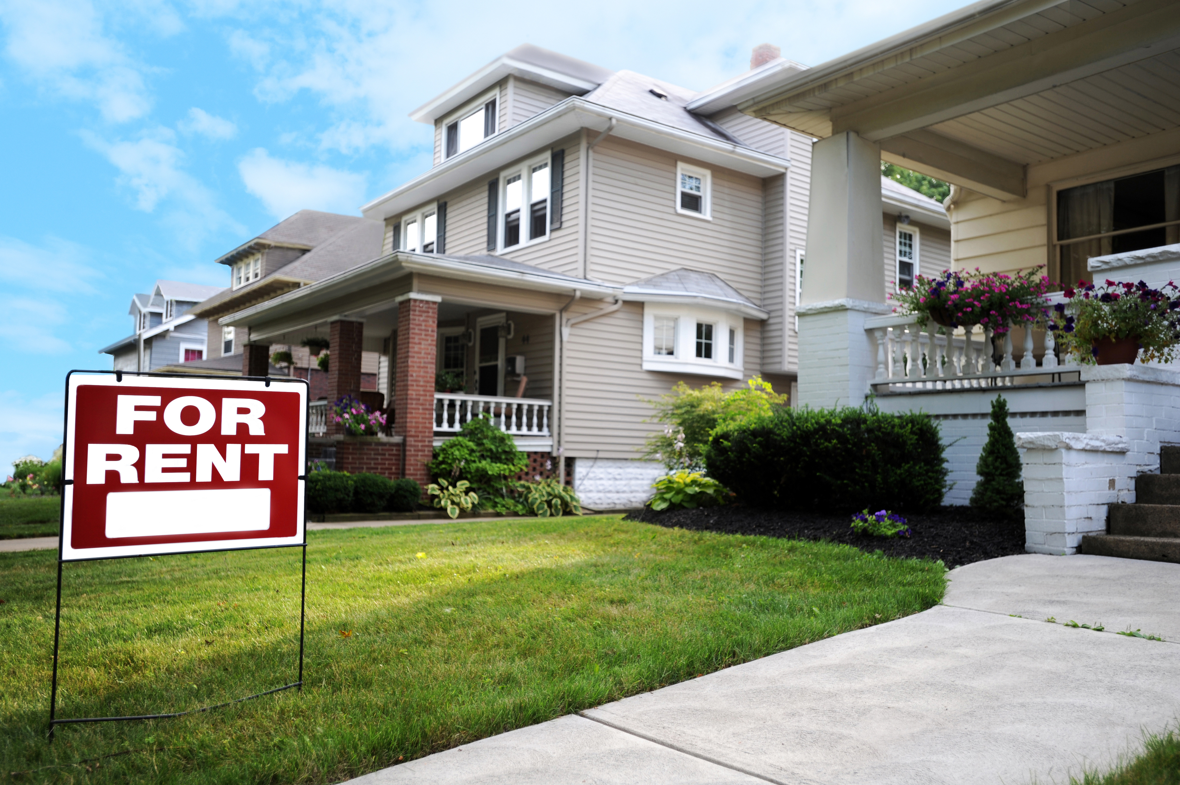 For Rent sign in front of a suburban rental home, highlighting the importance of landlord insurance coverage to protect property, tenants, and rental income