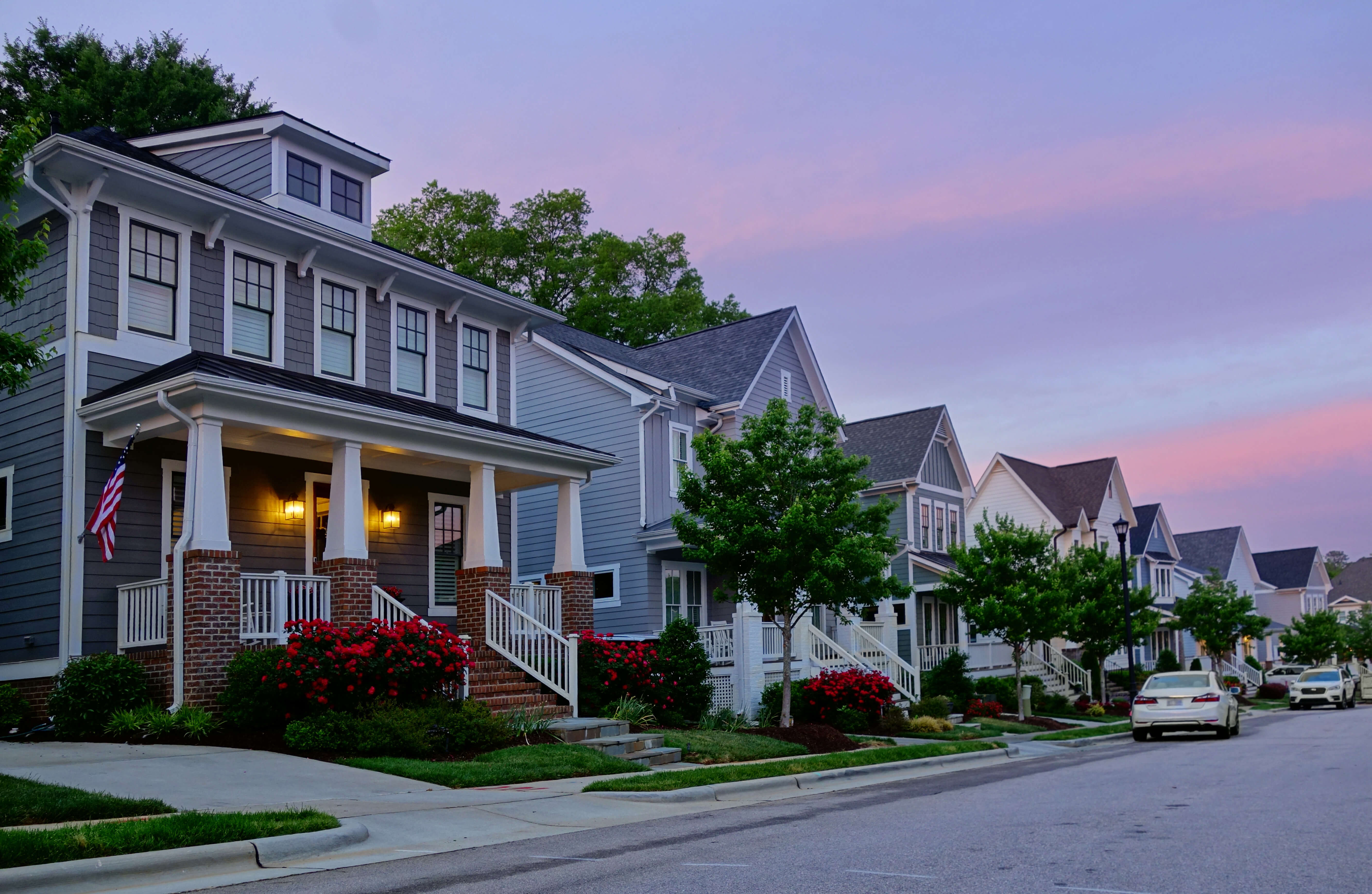 Row of modern homes in a quiet North Carolina neighborhood at dusk, representing insurance coverage designed for newly constructed homes.