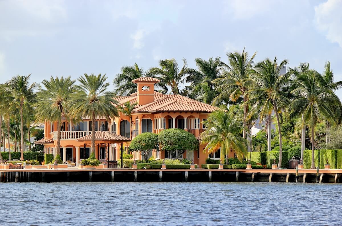 Luxury Florida home with modern design and tropical landscaping representing high value homeowners insurance coverage.